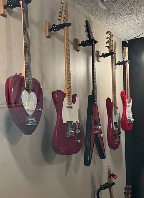Red guitars hung up.